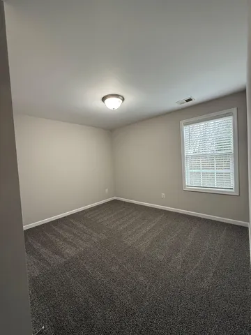 an empty room with a empty space and windows