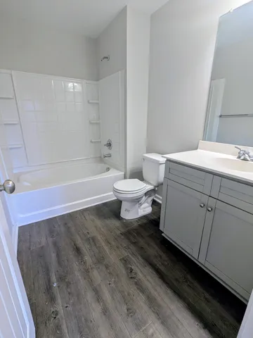 a bathroom with a sink a toilet and bathtub
