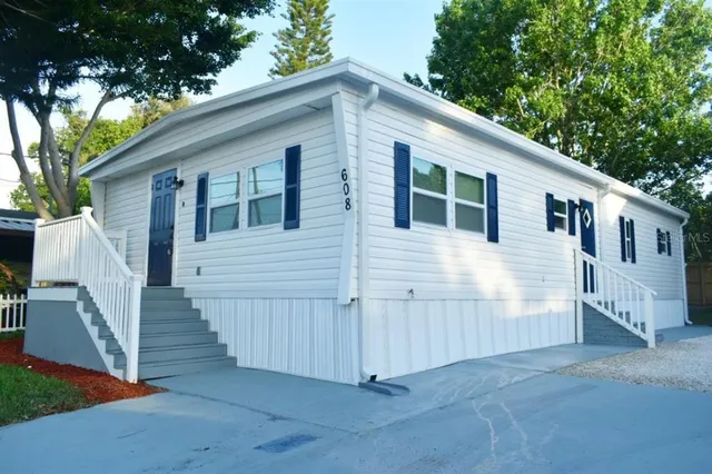 a view of a house with wooden fence