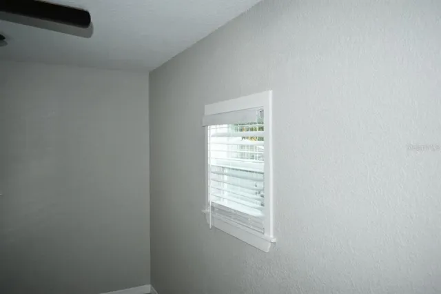 a view of an empty room and a window