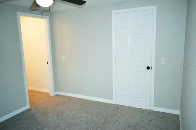 a view of an empty room and a window