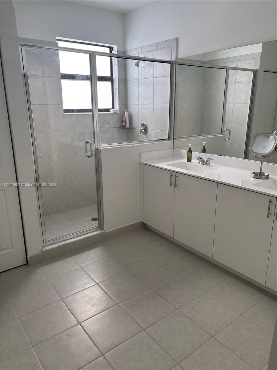 Goulds Miami, FL 33170 - Photo 5 of 8 a bathroom with a double vanity sink a mirror and a bathtub