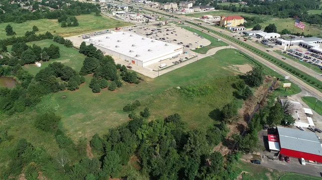 an aerial view of a residential houses with outdoor space and street view