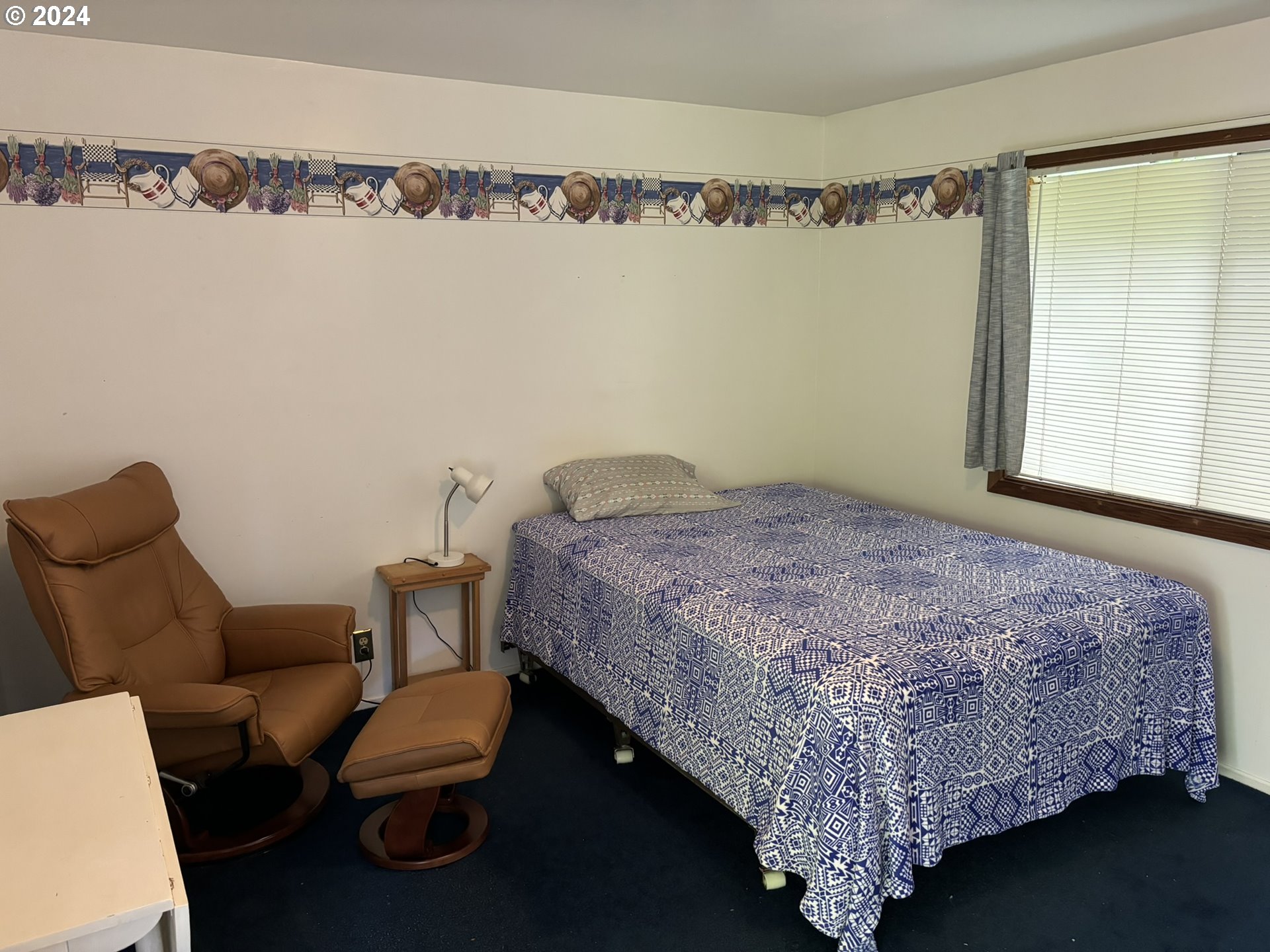 246 Horseshoe Bend Florence, OR 97439 - Photo 11 of 33 a bedroom with a bed and a chandelier in it