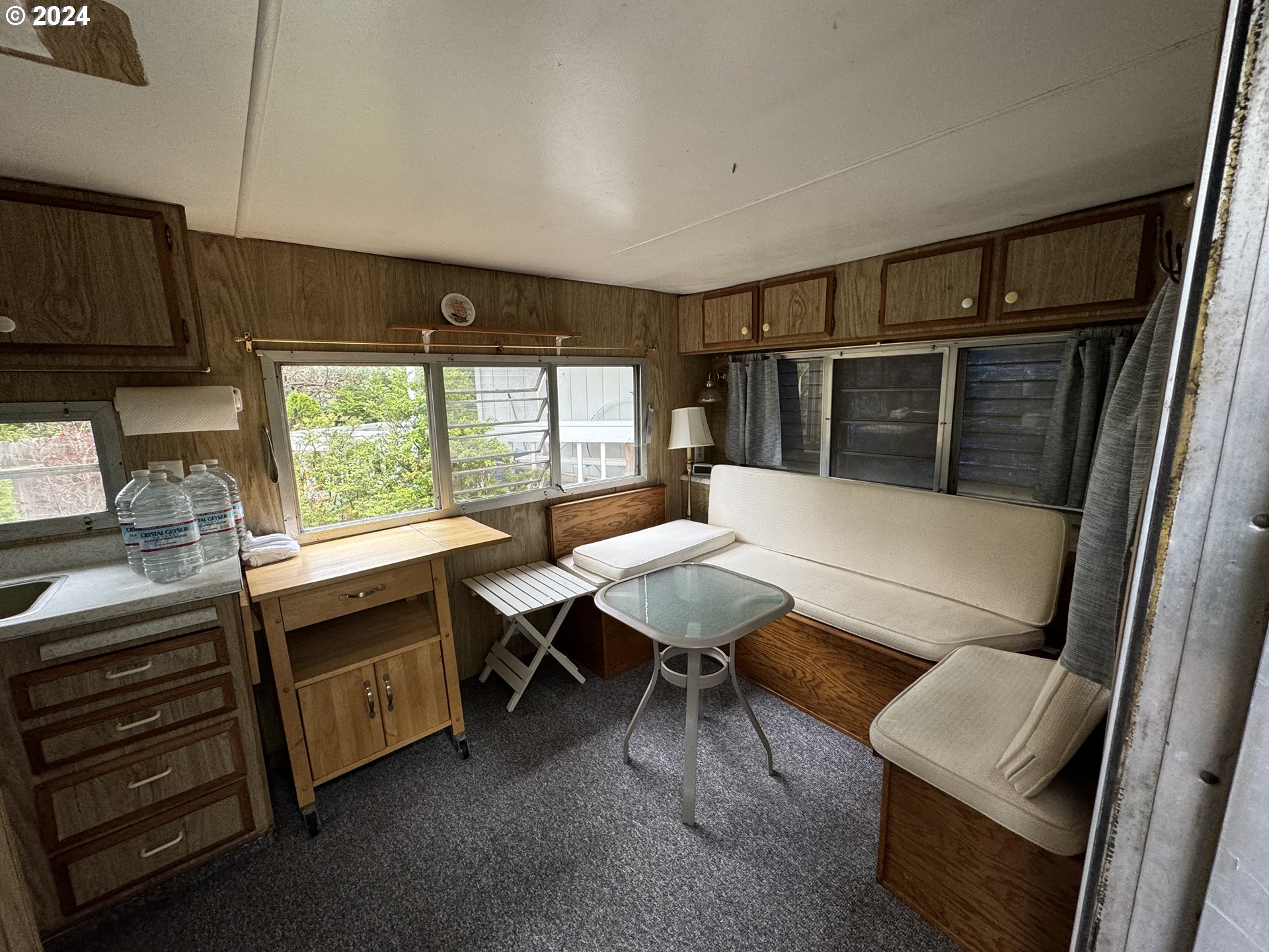 246 Horseshoe Bend Florence, OR 97439 - Photo 17 of 33 a kitchen with a table chairs sink and cabinets