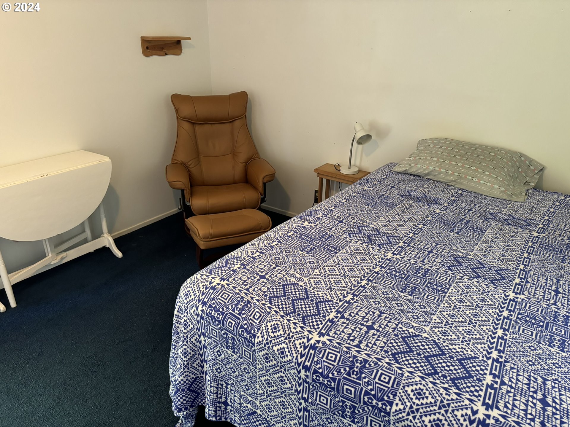 246 Horseshoe Bend Florence, OR 97439 - Photo 10 of 33 a bedroom with a bed and a couch