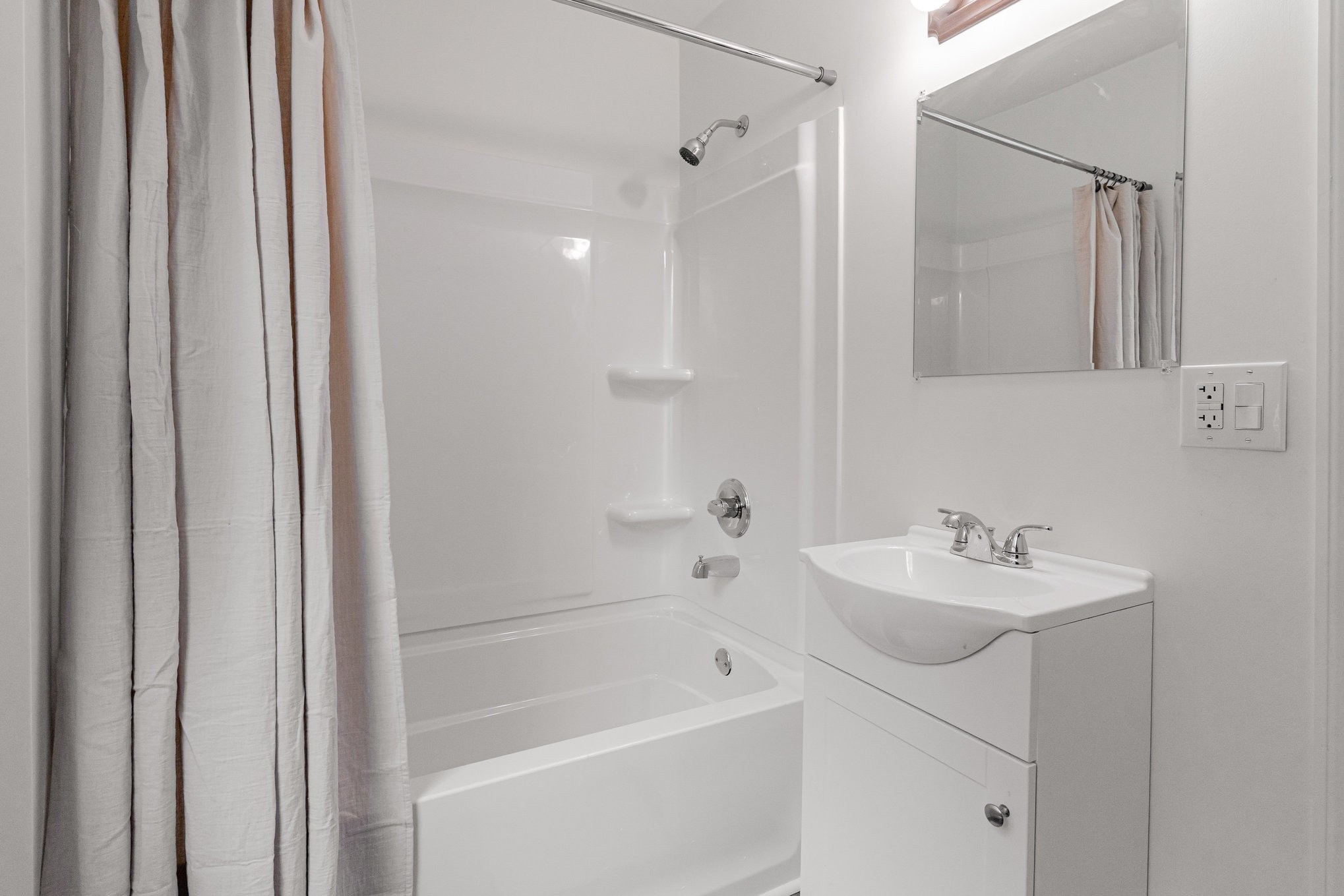 1307 Atlas Street Murfreesboro, TN 37130 - Photo 18 of 24 a bathroom with a sink a mirror and a bathtub