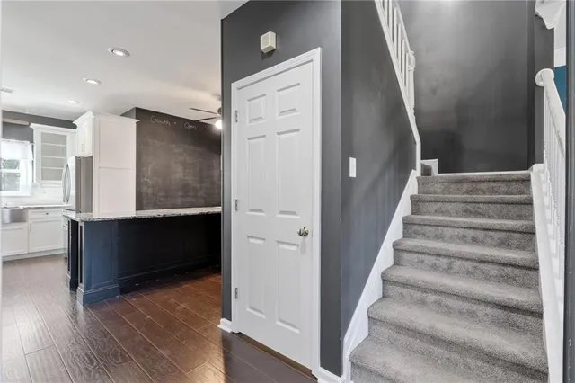 a view of a hallway with a chandelier fan and entryway