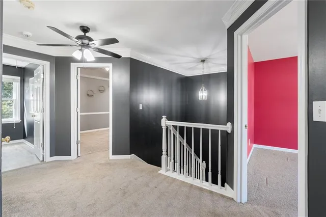 a view of an empty room with a chandelier fan