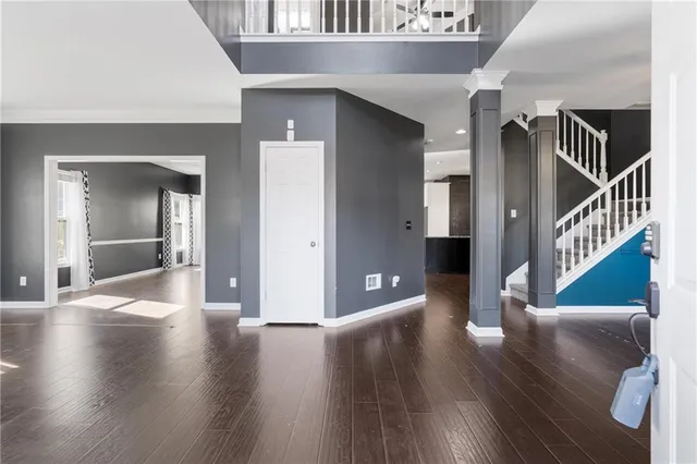 a view of a hallway view with wooden floor and staircase