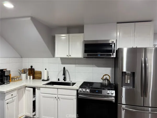 a kitchen with a sink a stove and refrigerator