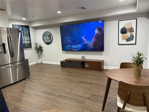 a view of kitchen with stainless steel appliances granite countertop a stove a refrigerator and a dining table