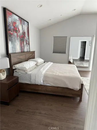 a bedroom with bed and wall painting