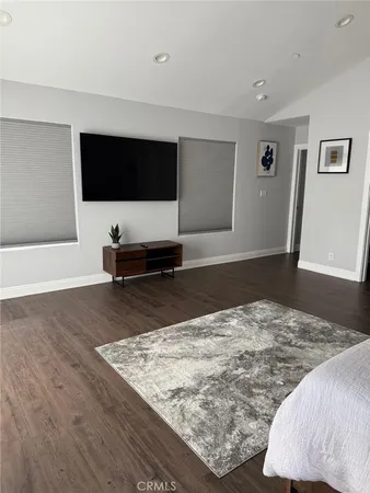 a living room with a flat screen tv and gym equipment