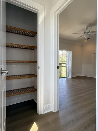 a view of a room with wooden floor