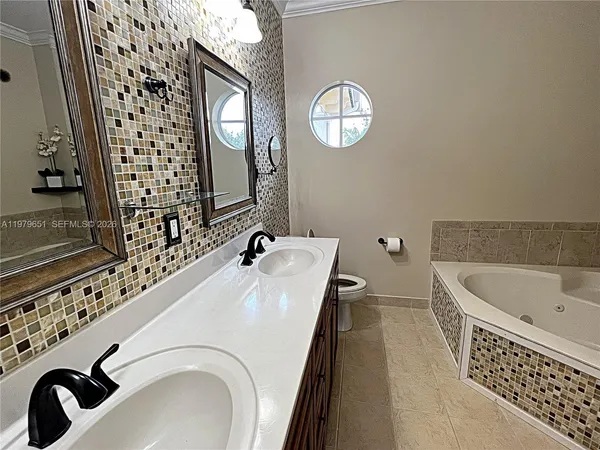 a view of a patio with couches table and chairs potted plants