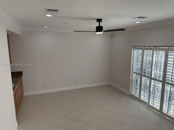 an empty room with a empty space and a ceiling fan