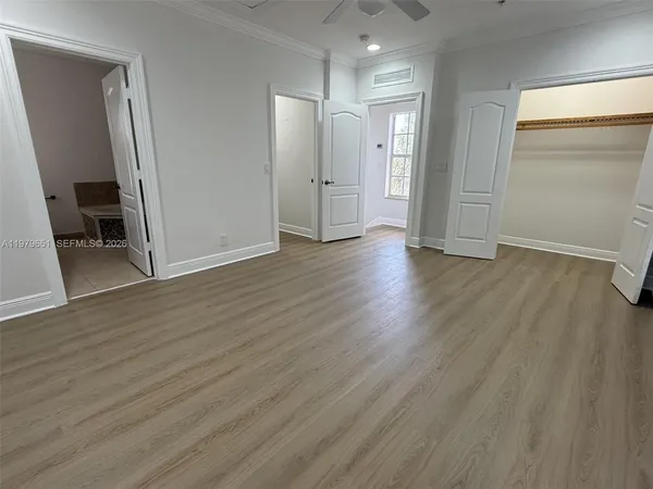 an empty room with wooden floor and closet