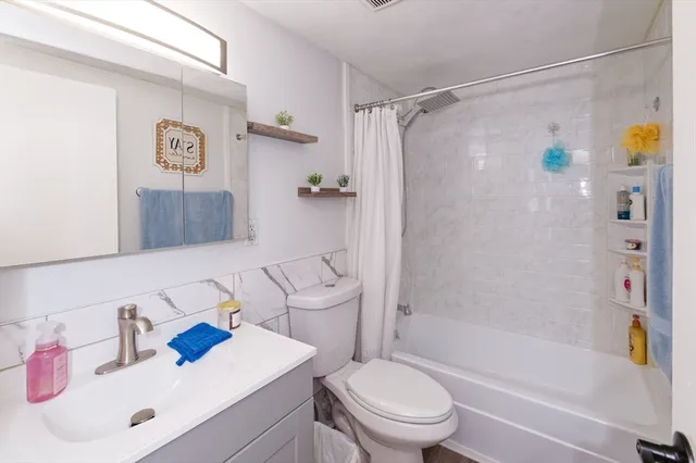 a bathroom with a sink toilet and shower