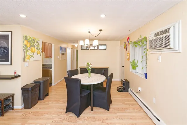 a view of a dining room with furniture and chandelier