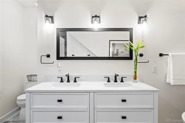 a bathroom with vanity sink and mirror