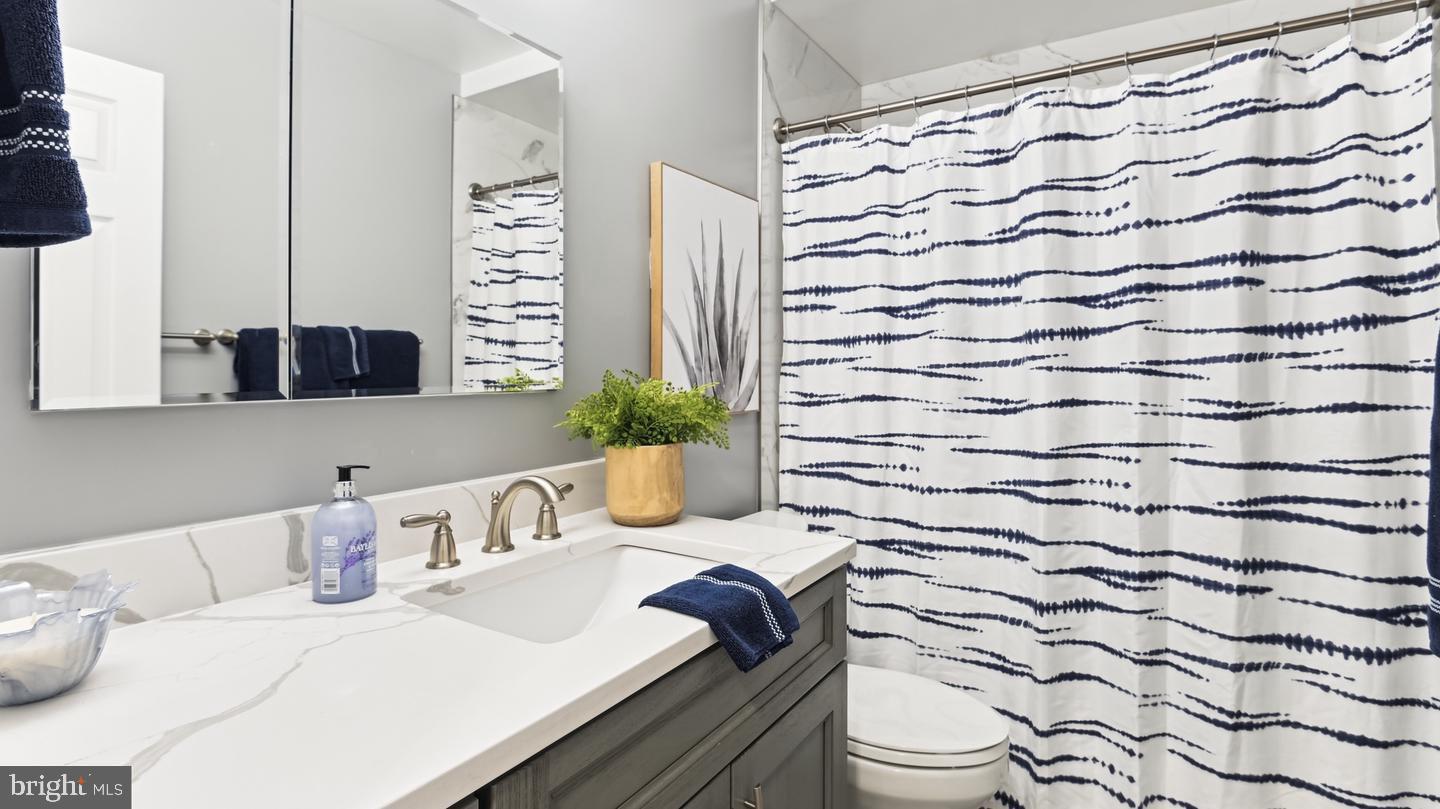 8352 Forrester Boulevard, Unit 456 Springfield, VA 22152 - Photo 11 of 18 a bathroom with a sink toilet and shower