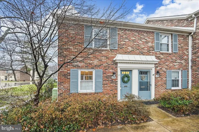 front view of a brick house with a large windows