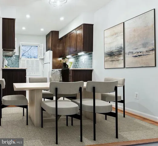 a kitchen with kitchen island a table and chairs in it