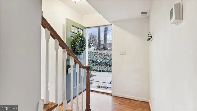 a view of an entryway with wooden floor