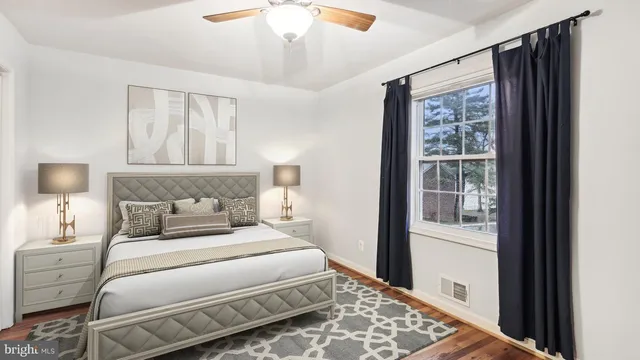 a bedroom with a large bed and a window