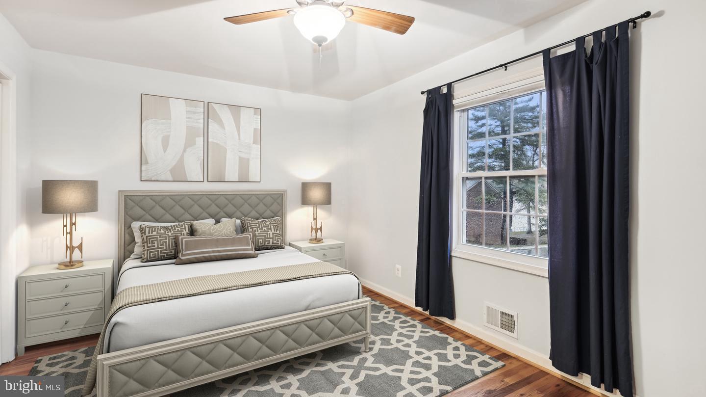 8352 Forrester Boulevard, Unit 456 Springfield, VA 22152 - Photo 8 of 18 a bedroom with a large bed and a window