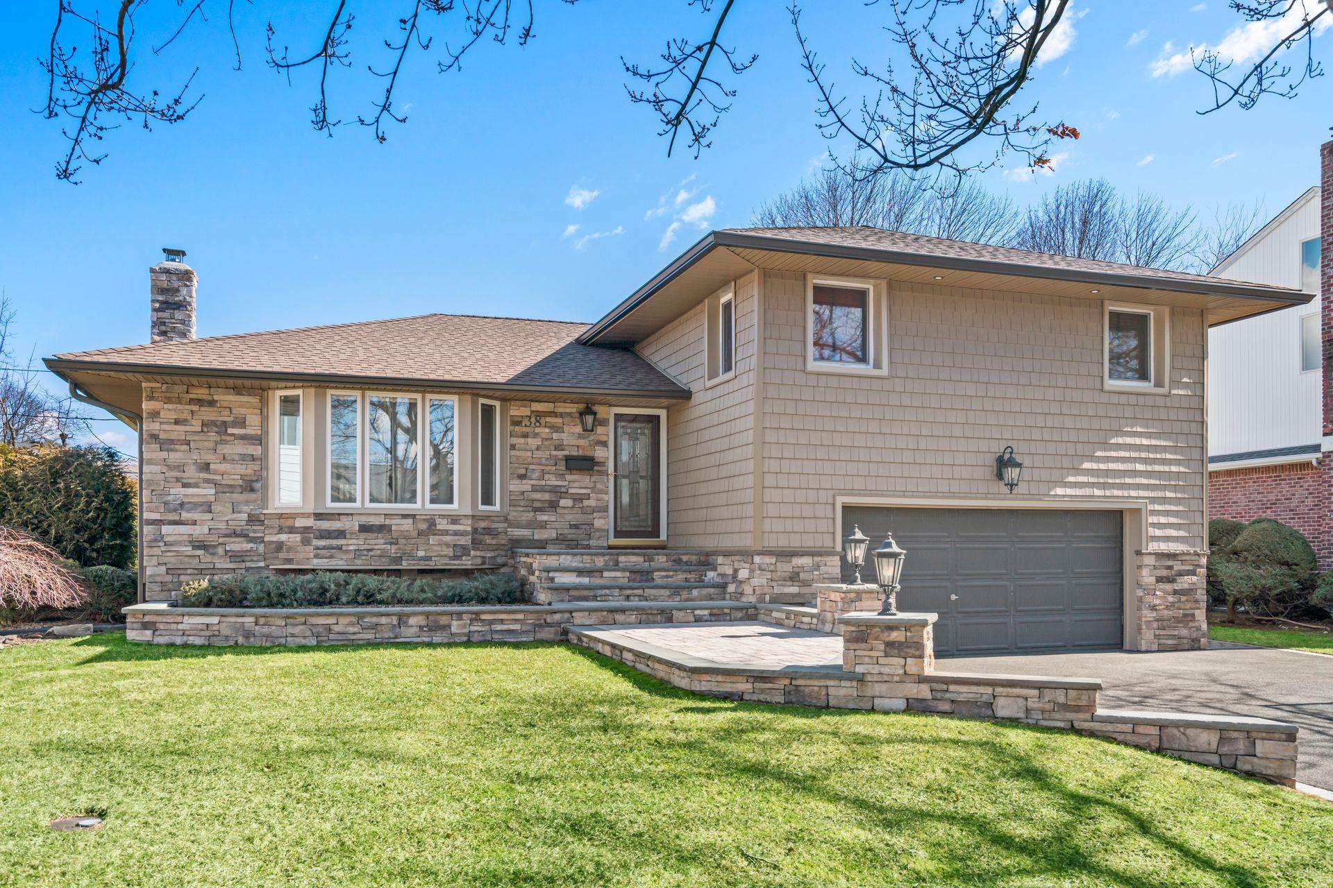 38 Roxton Road Plainview, NY 11803 - Photo 1 of 1 a front view of a house with swimming pool