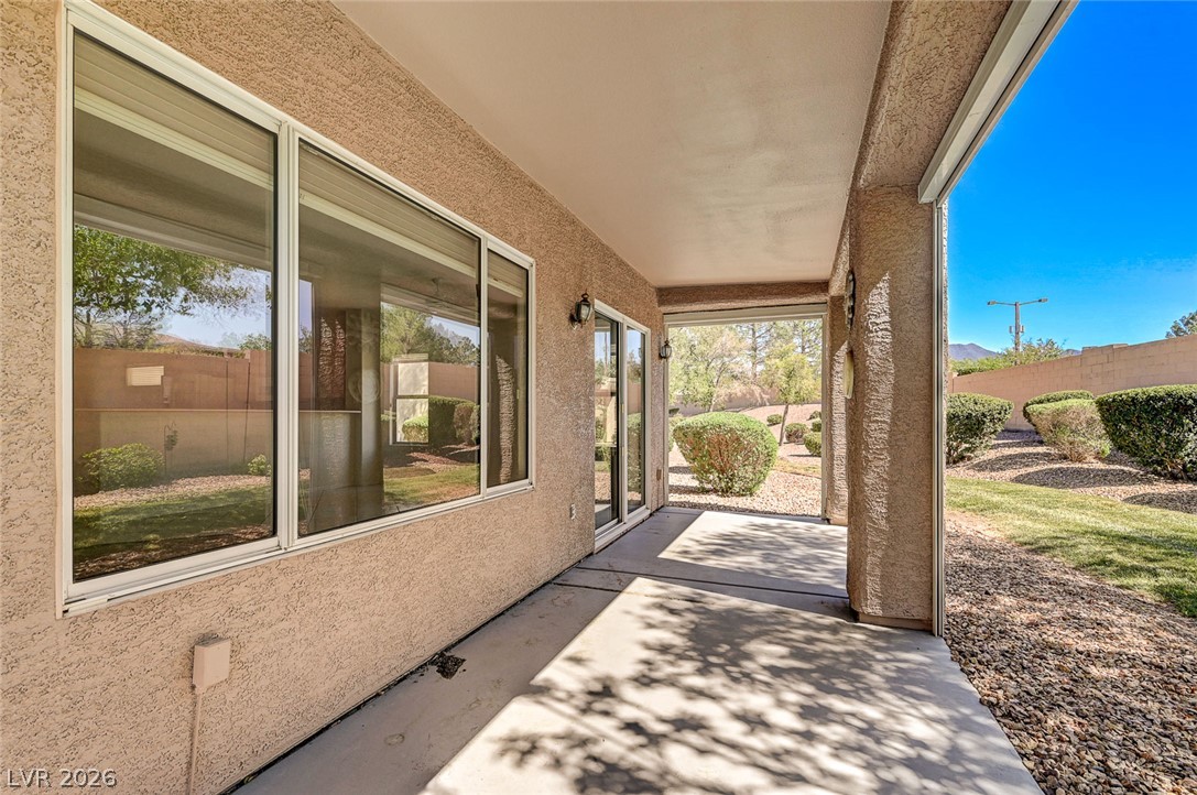 2529 Springville Way Henderson, NV 89052 - Photo 52 of 70 Shaded concrete patio overlooks a manicured yard with desert landscaping.