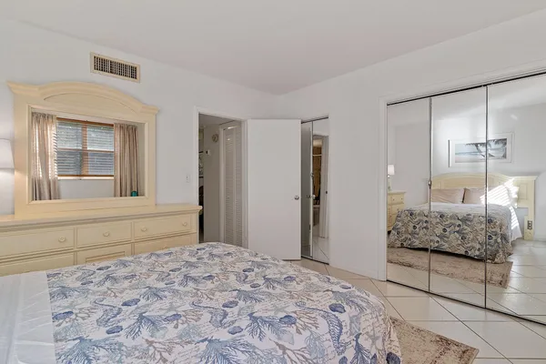 a utility room with stainless steel appliances wooden floor sink and refrigerator