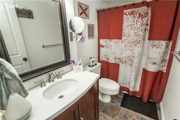 a bathroom with a sink toilet and mirror