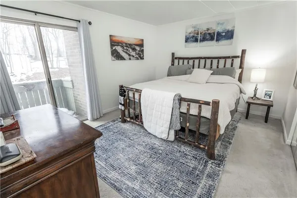 a bed sitting in a bedroom next to a window