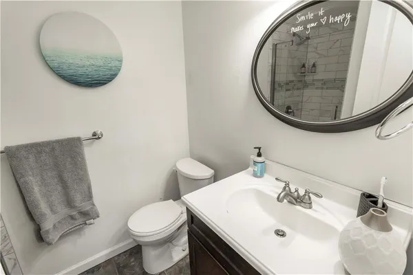 a bathroom with a sink mirror and toilet