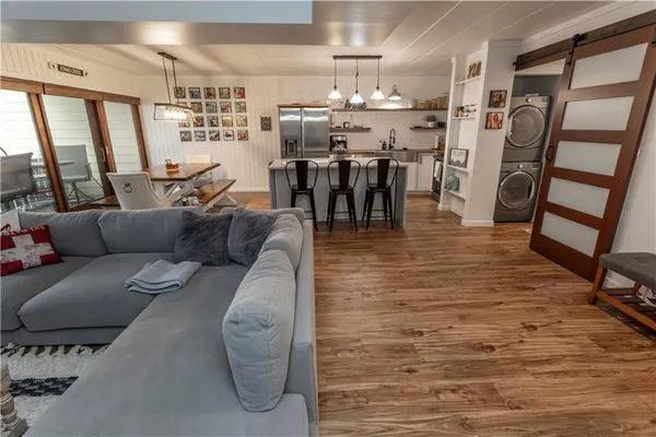 a living room with furniture dining table and wooden floor