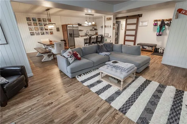 a living room with furniture and wooden floor