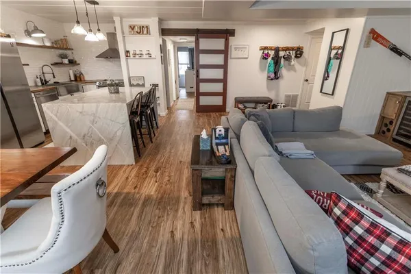 a living room with furniture and wooden floor