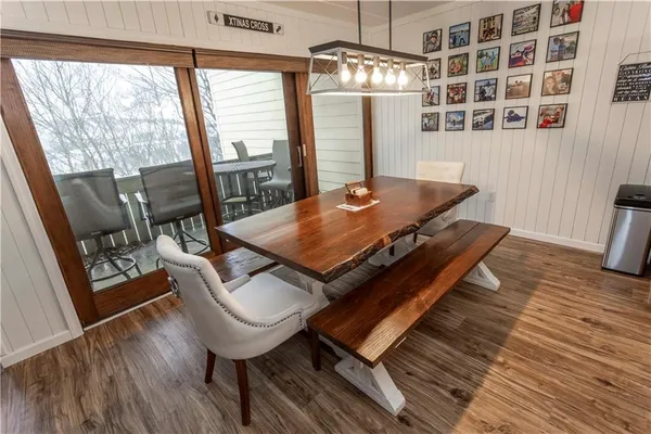 a living room with a table chairs and a large window