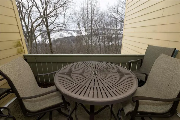 a view of a roof deck with table and chairs