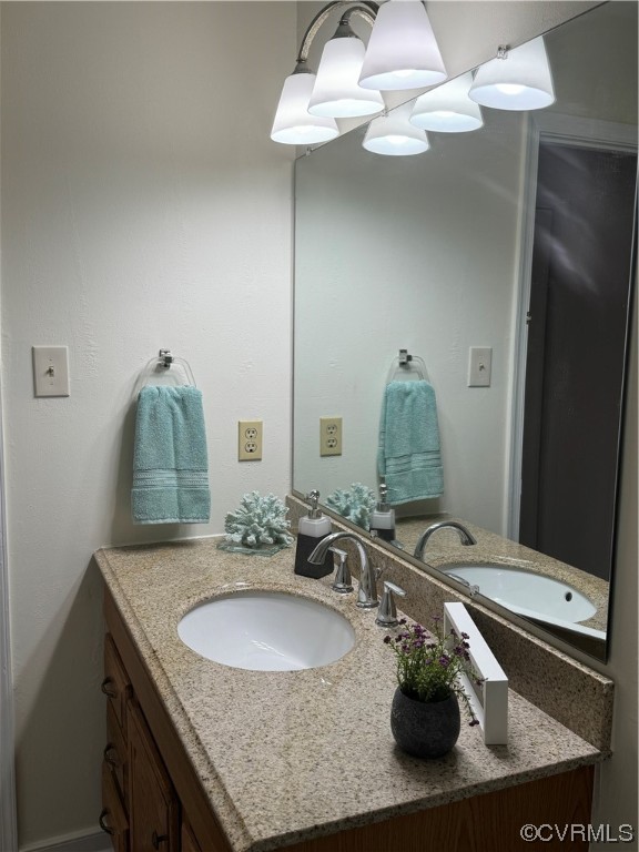 15613 Roland View Drive Chester, VA 23831 - Photo 12 of 18 a bathroom with a granite countertop sink and a mirror