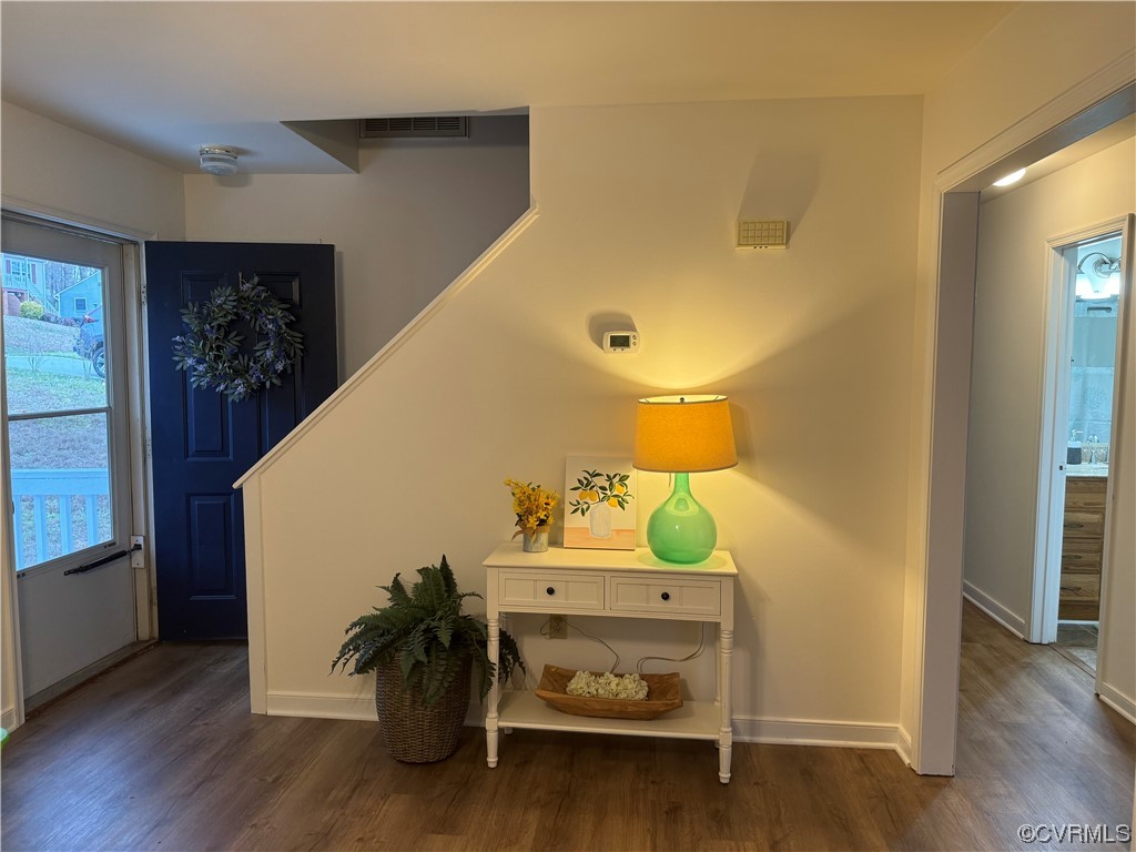15613 Roland View Drive Chester, VA 23831 - Photo 3 of 18 a hallway with a dining table chairs and wooden floor