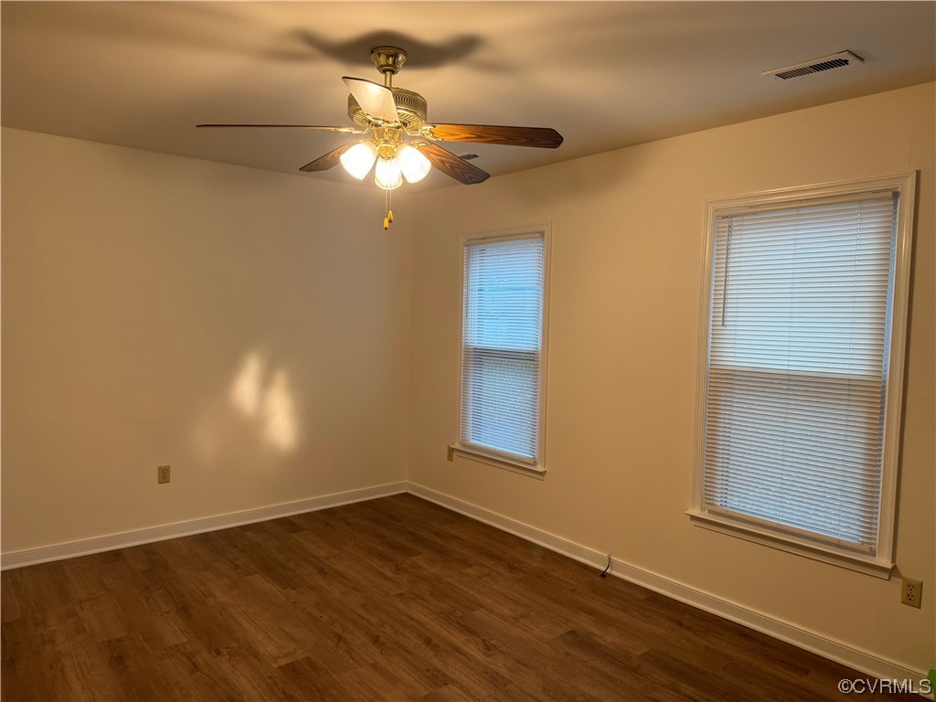 15613 Roland View Drive Chester, VA 23831 - Photo 4 of 18 an empty room with wooden floor fan and windows