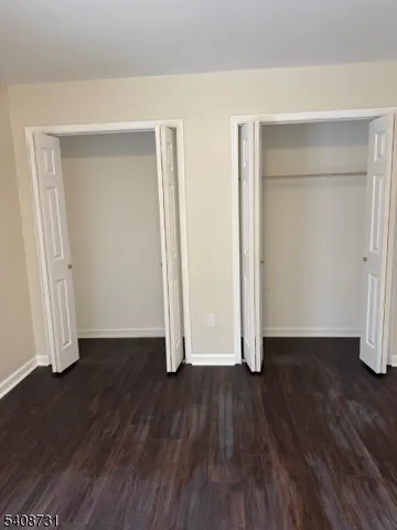 an empty room with wooden floor and closet