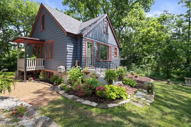 a view of a house with wooden fence and garden