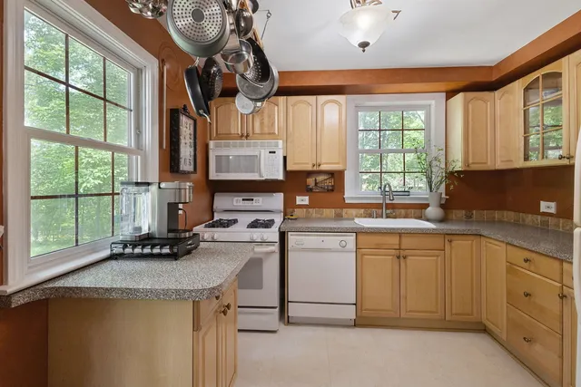 a kitchen with a sink cabinets and window