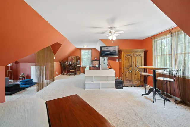 a bed room with furniture and a large window