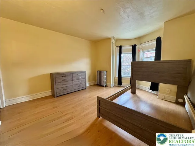 a bedroom with a bed and window